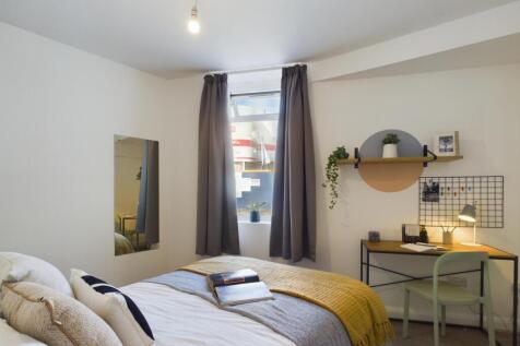 A bright and inviting double bedroom featuring ...