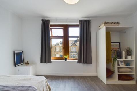A bright and inviting double bedroom featuring ...