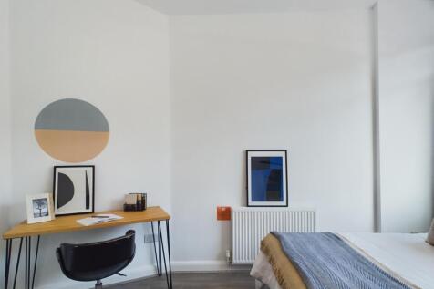 A stylish and well-lit double bedroom featuring...