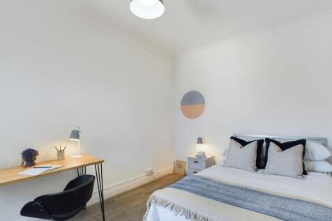 A bright and inviting double bedroom featuring ...