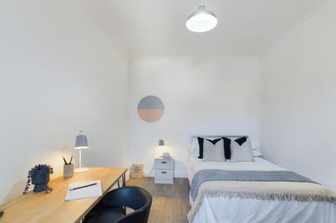 A bright and inviting double bedroom with moder...