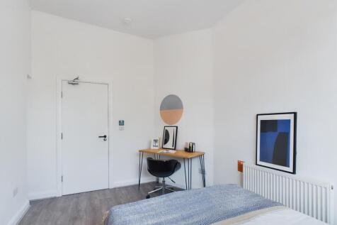 A bright and inviting double bedroom featuring ...