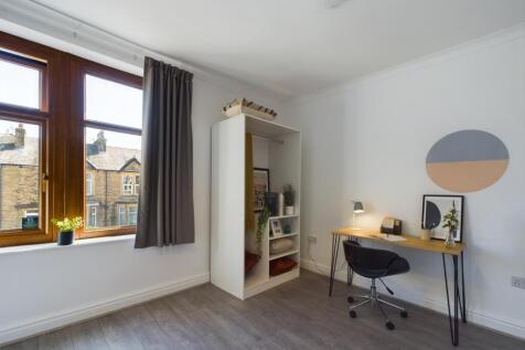 A bright and inviting double bedroom with ample...