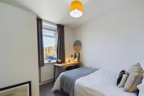 A bright and stylish double bedroom with modern...