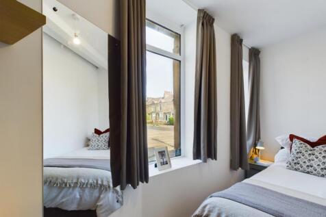 A bright and inviting double bedroom featuring ...