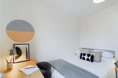 A bright and inviting double bedroom with a sty...
