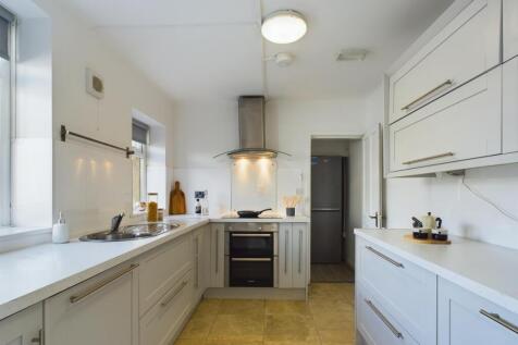 A modern and spacious kitchen with ample natura...