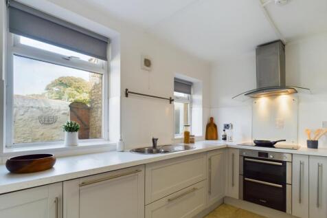 A bright and modern kitchen with ample counter ...