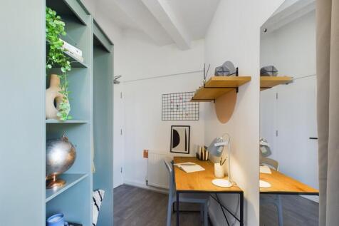 A bright and tidy communal workspace with a sty...