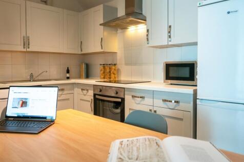 A bright and tidy kitchenette with modern appli...