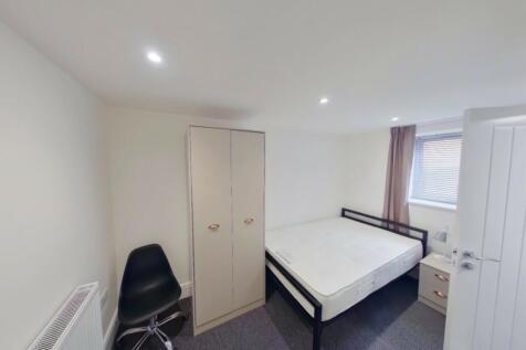 A spacious and bright double bedroom featuring ...