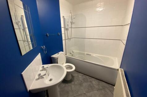 A modern and clean large bathroom featuring a b...