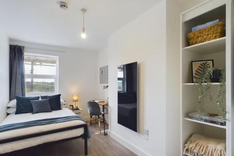 A bright and inviting double bedroom with moder...