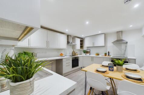 A bright and modern kitchen featuring ample spa...