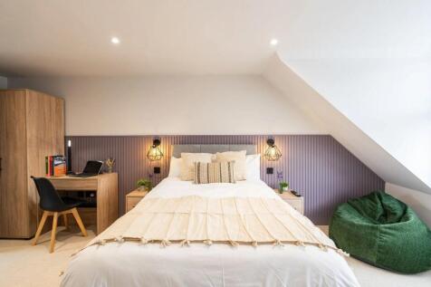 Bright, freshly styled bedroom with a comfortab...