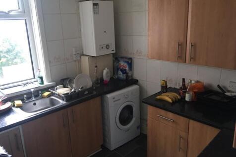 Bright kitchen featuring modern cabinetry, ampl...