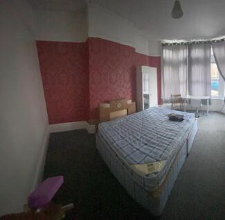 Spacious double bedroom featuring a large bed, ...