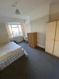 Spacious double bedroom featuring large windows...