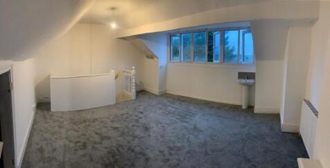 Spacious and bright living room featuring large...