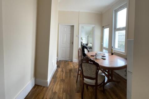 A well-lit kitchen with a spacious dining area,...