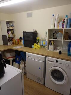 Well-equipped utility room with washer and drye...