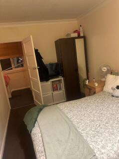 Well-presented double bedroom with a neatly mad...