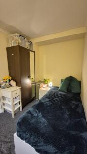 Cozy single bedroom with a neatly made bed, bed...