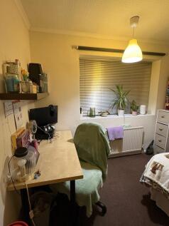 Cosy single bedroom with a study desk by the wi...