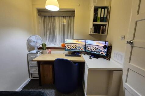 Neat, well-organised study nook with a dual-mon...