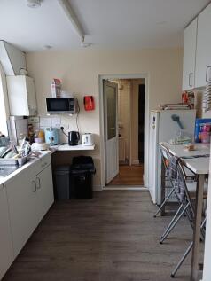 Bright, practical communal kitchen with modern ...