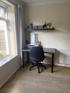 Bright corner workspace with a large window, si...