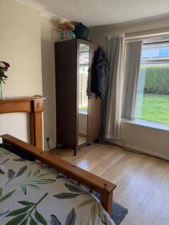 Bright bedroom with a large window overlooking ...