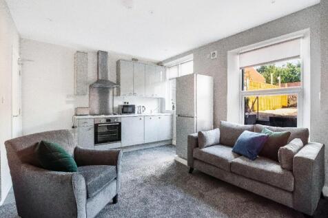 Bright open-plan living area with a fitted kitc...