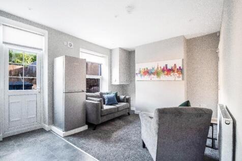 Bright, modern living room with neutral décor, ...