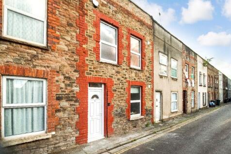 Traditional stone-and-brick terraced street wit...