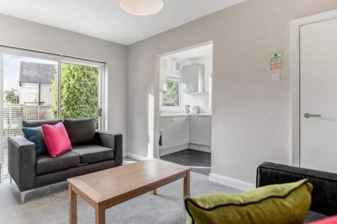 Bright, modern living room with a comfortable t...