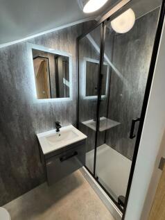 Contemporary ensuite bathroom with a sleek vani...
