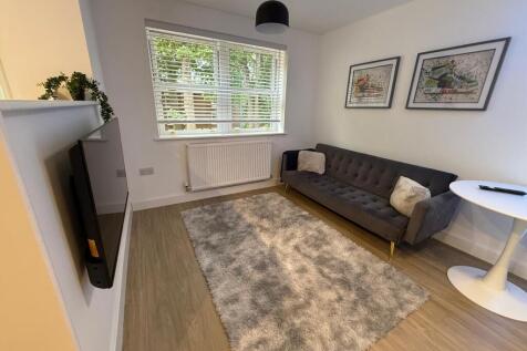 Bright, modern living room with a large window ...