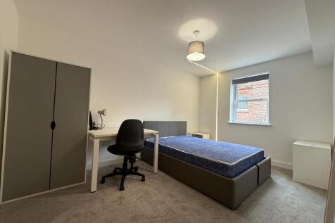 Bright, neutrally decorated bedroom with double...