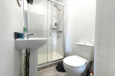 Bright, modern bathroom with a tiled walk-in sh...