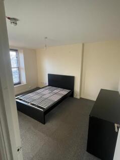 A spacious and well-lit double bedroom, perfect...
