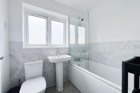Bright, modern bathroom with a clean white suit...