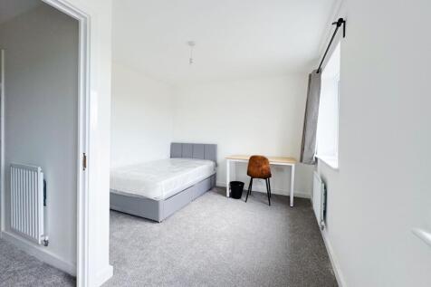 Bright, freshly redecorated bedroom with neutra...