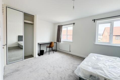 Bright, freshly carpeted master bedroom with tw...