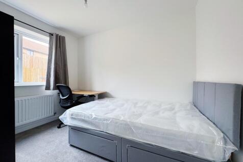 Bright, neatly presented bedroom with a comfort...