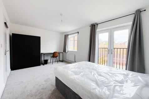 Bright, spacious bedroom with large french door...