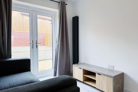 Bright, modern living area with full-height pat...