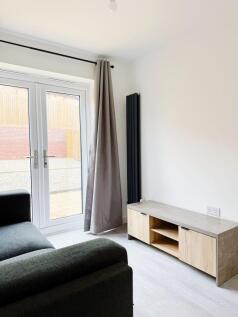 Bright, modern living area with large glass doo...