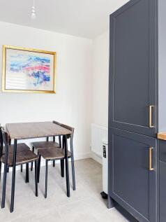 Bright modern kitchen dining nook with a compac...