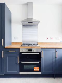 Contemporary fitted kitchen with deep blue shak...